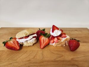 strawberry biscuit and shortcake desserts decoratively plated on cutting board