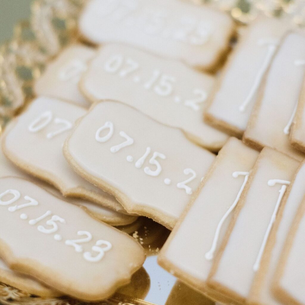 White frosted “Save the Date” cookies with elegant lettering, perfect for weddings, showers, or special event announcements.